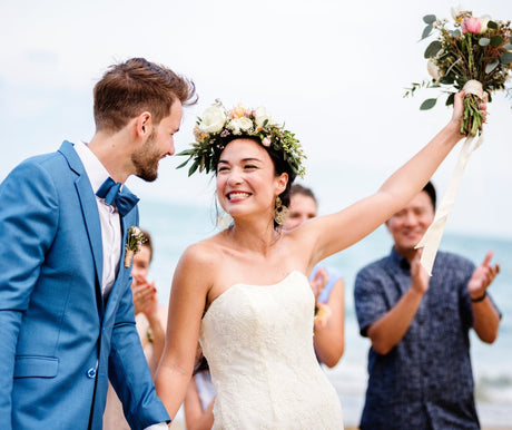 A happy bride and groom at a beach wedding.