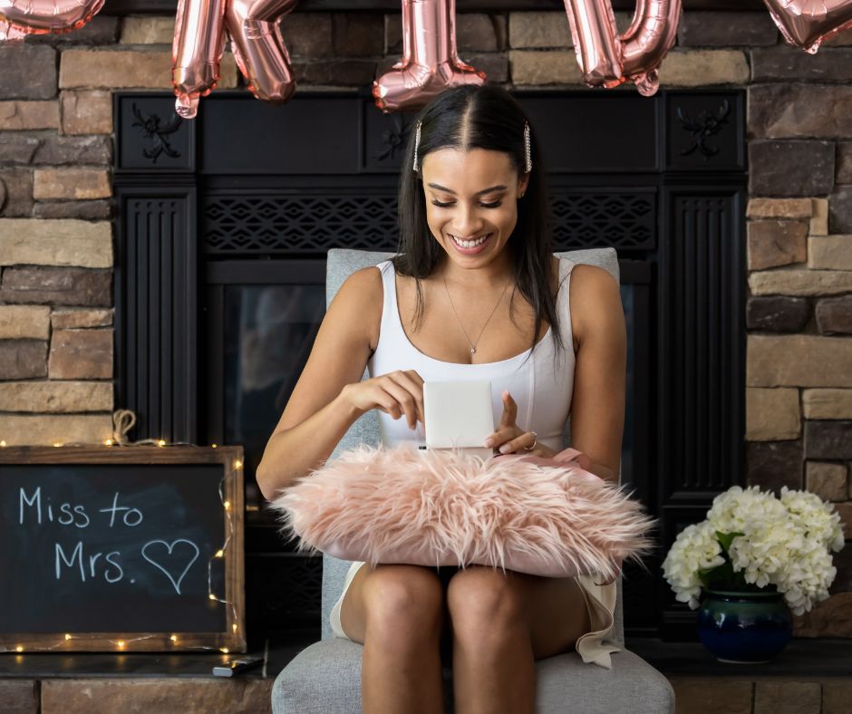 A bride-to-be opening gifts at her bridal shower.